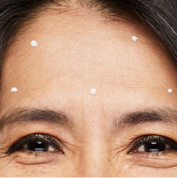 Woman with five dots of Mary Kay Clinical Solutions Dynamic Wrinkle Limiter across her forehead